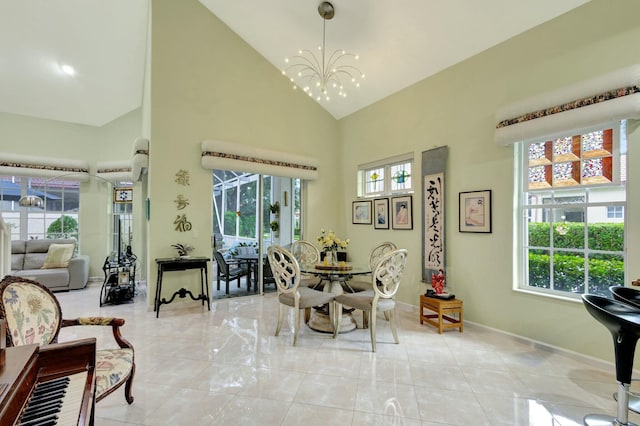 dining room featuring a notable chandelier, light tile patterned flooring, plenty of natural light, and high vaulted ceiling