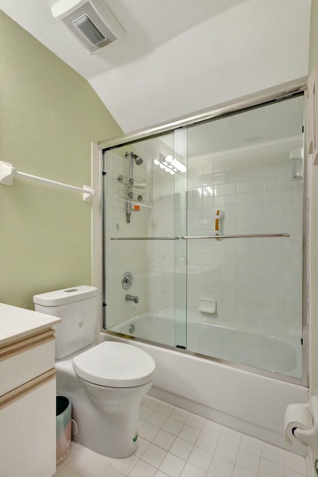 full bathroom featuring visible vents, toilet, shower / bath combination with glass door, tile patterned floors, and vanity