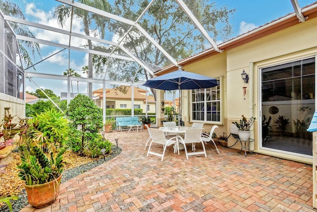 view of patio featuring a lanai and outdoor dining area