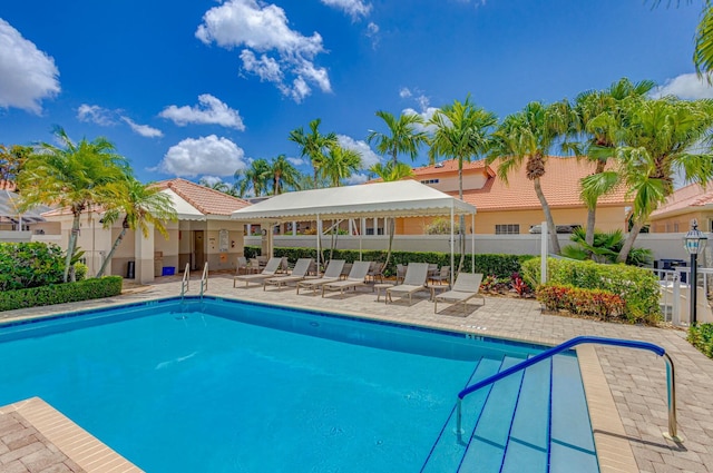 pool featuring a patio and fence