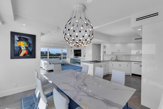 dining space with visible vents, baseboards, finished concrete flooring, and a chandelier