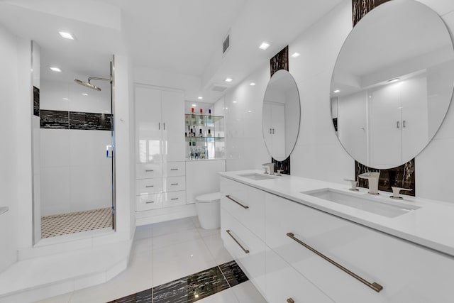 full bath with a shower stall, tile walls, visible vents, and a sink