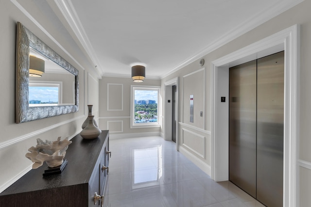 hallway with light tile patterned floors, elevator, crown molding, and a decorative wall