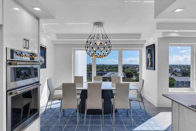 dining space with an inviting chandelier and baseboards