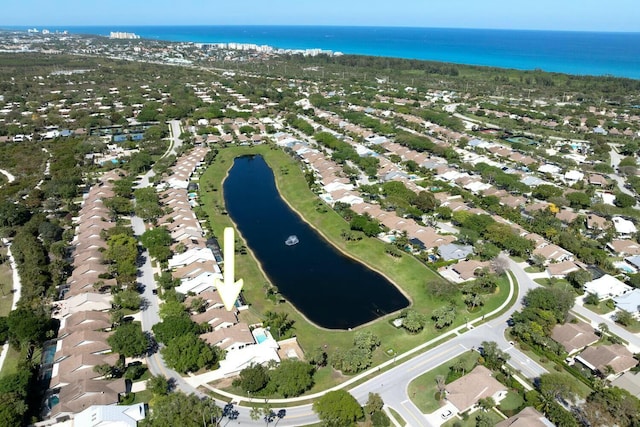 drone / aerial view with a water view and a residential view