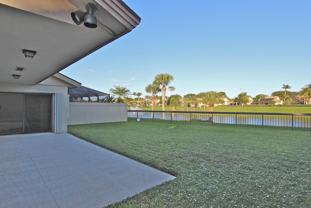 view of yard featuring a water view and a fenced backyard