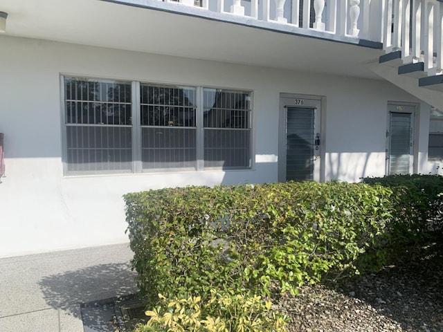 doorway to property featuring stucco siding