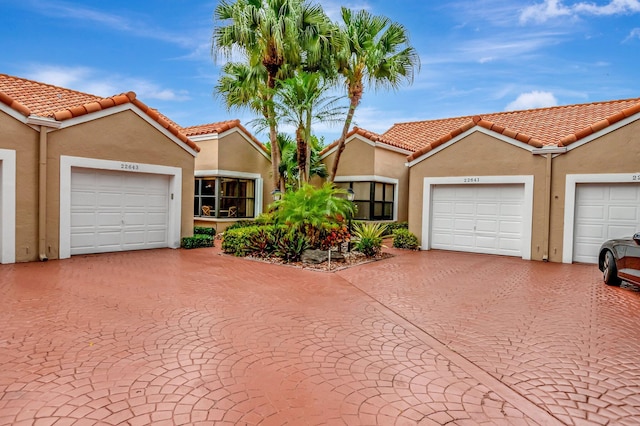 mediterranean / spanish-style house featuring stucco siding and a tile roof