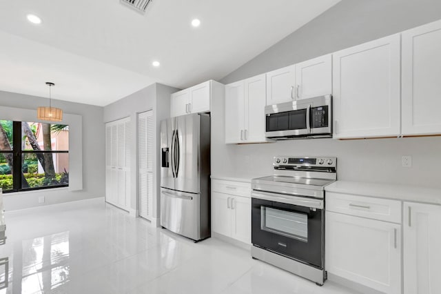 kitchen featuring visible vents, light countertops, vaulted ceiling, stainless steel appliances, and white cabinetry