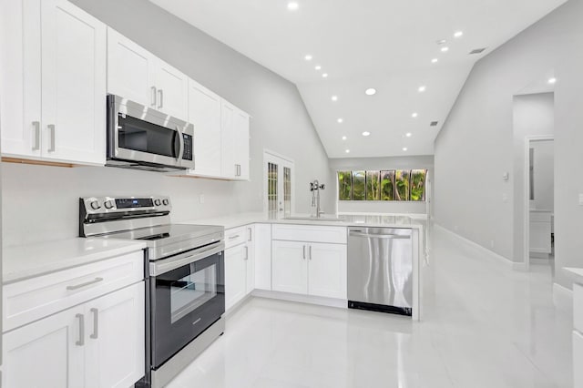 kitchen with a sink, stainless steel appliances, white cabinets, and light countertops