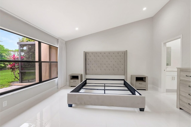 bedroom with lofted ceiling, recessed lighting, baseboards, and ensuite bathroom