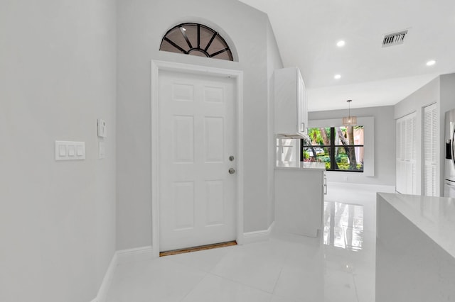 entryway with light tile patterned floors, visible vents, recessed lighting, and baseboards