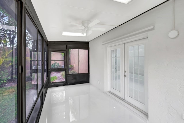 unfurnished sunroom featuring french doors and ceiling fan