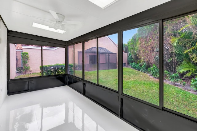 unfurnished sunroom with a ceiling fan