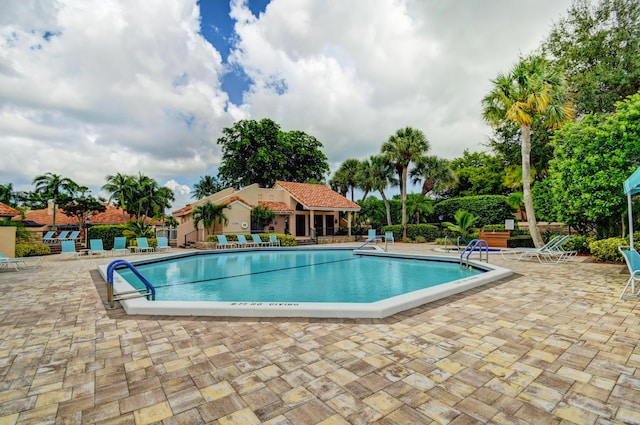 community pool featuring a patio and fence