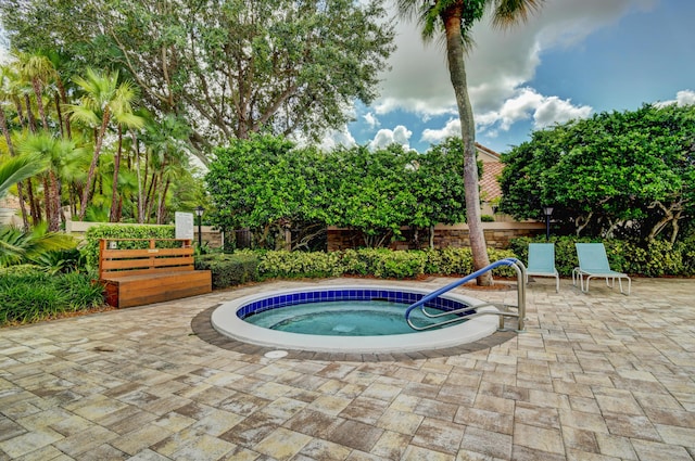 view of swimming pool featuring a patio area, a hot tub, and fence