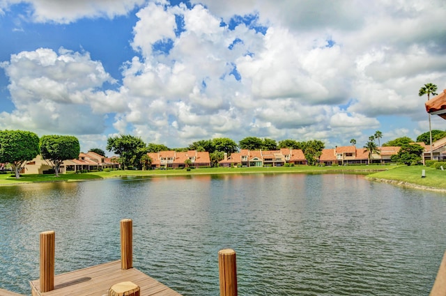 view of dock with a residential view and a water view