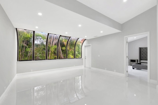 empty room featuring recessed lighting and baseboards