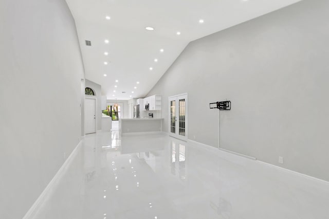 unfurnished living room with visible vents, high vaulted ceiling, marble finish floor, recessed lighting, and baseboards