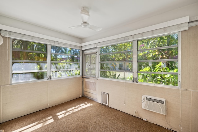 unfurnished sunroom with an AC wall unit and ceiling fan