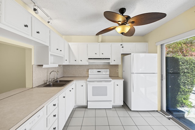 kitchen featuring white appliances, a sink, decorative backsplash, white cabinets, and under cabinet range hood