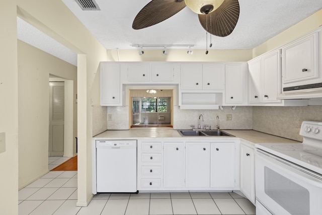 kitchen with under cabinet range hood, white cabinets, white appliances, and a sink