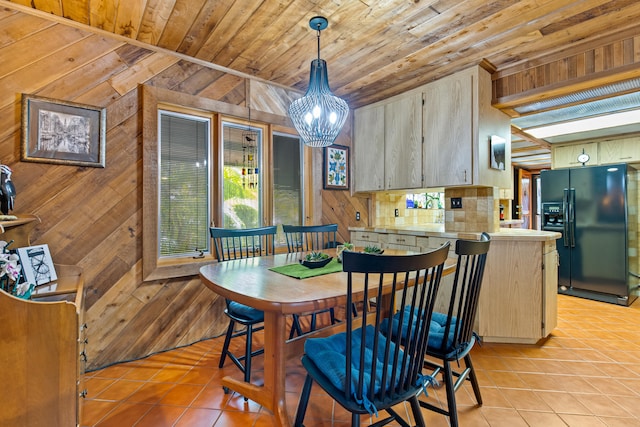 dining room with wooden walls, light tile patterned floors, wood ceiling, and a chandelier