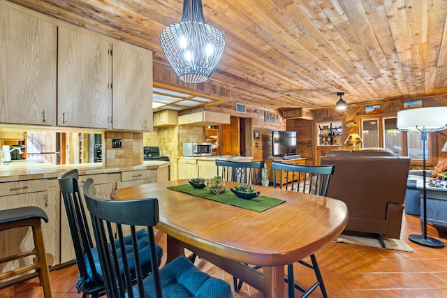 dining area with wooden ceiling, light tile patterned floors, ceiling fan with notable chandelier, and visible vents