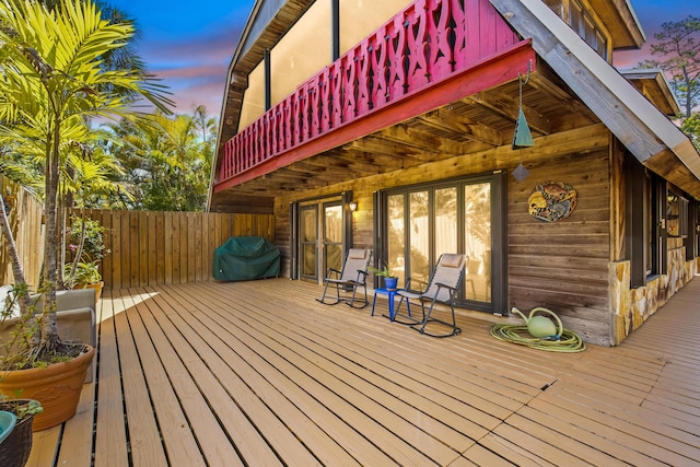 wooden terrace featuring fence