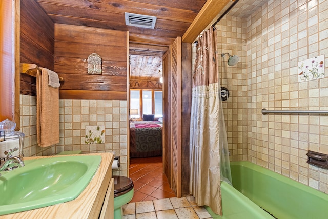 full bathroom featuring visible vents, toilet, shower / bath combo with shower curtain, tile patterned floors, and vanity