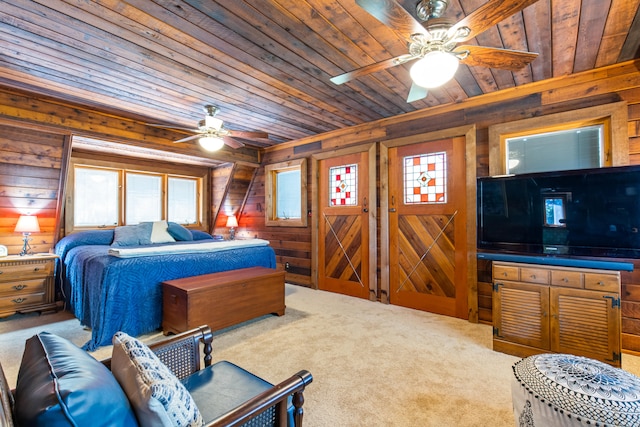 bedroom featuring a ceiling fan, wooden walls, wooden ceiling, and carpet flooring