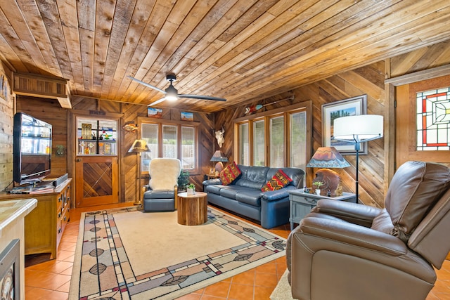 living room featuring wood ceiling, light tile patterned floors, a healthy amount of sunlight, and wooden walls