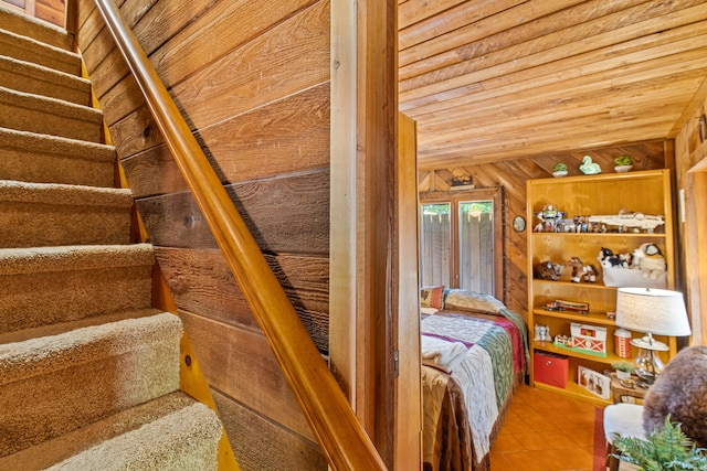 unfurnished bedroom featuring tile patterned floors, wooden walls, and wooden ceiling