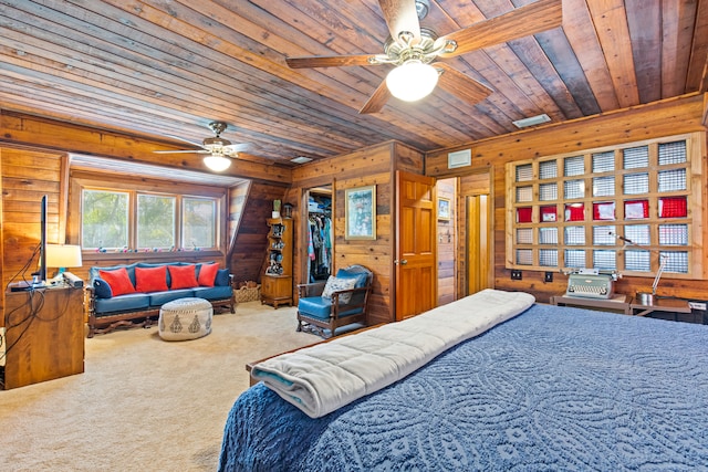 bedroom with a ceiling fan, visible vents, carpet floors, wood ceiling, and wood walls