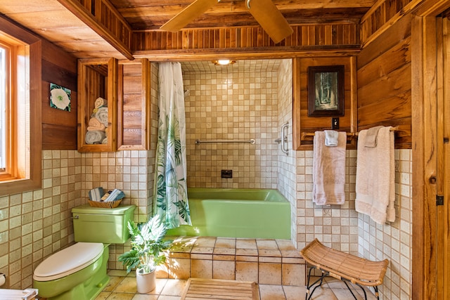 full bath featuring tile walls, toilet, wood ceiling, and shower / tub combo with curtain