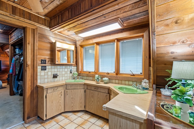 kitchen featuring a sink, decorative backsplash, and tile countertops