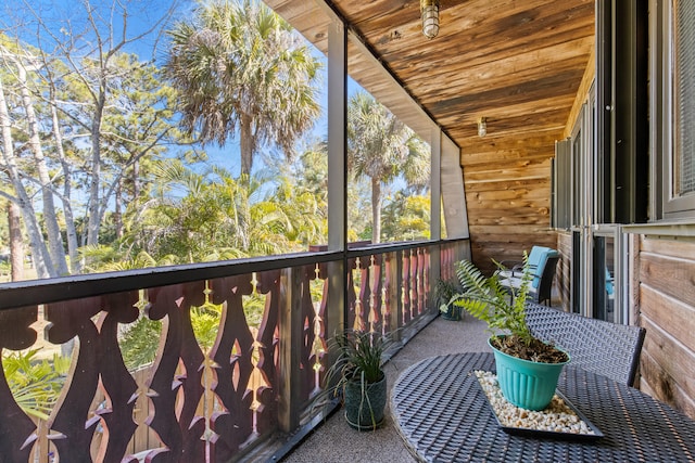 unfurnished sunroom with wooden ceiling and vaulted ceiling