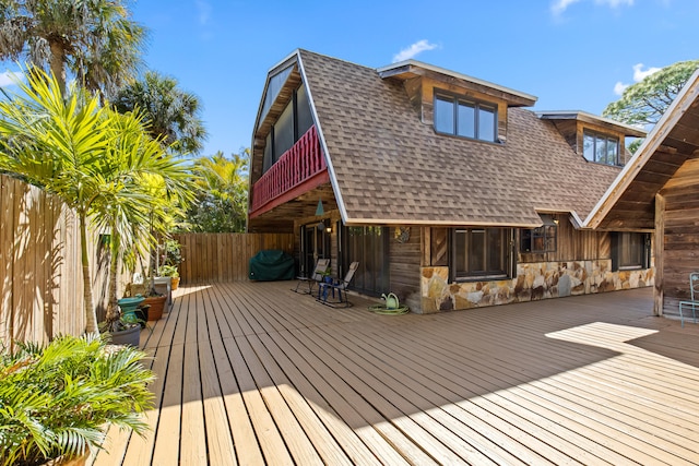 wooden terrace featuring fence