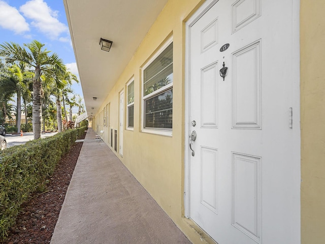 entrance to property featuring stucco siding