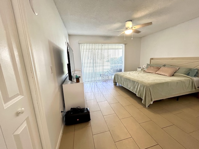 bedroom featuring baseboards, a textured ceiling, a ceiling fan, and access to outside