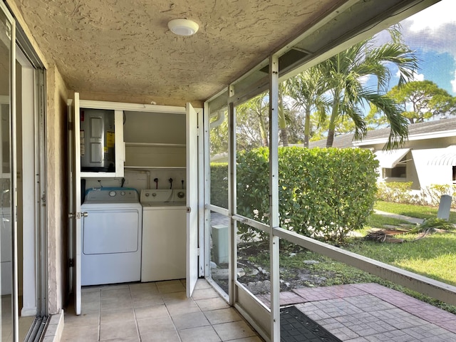 unfurnished sunroom featuring separate washer and dryer