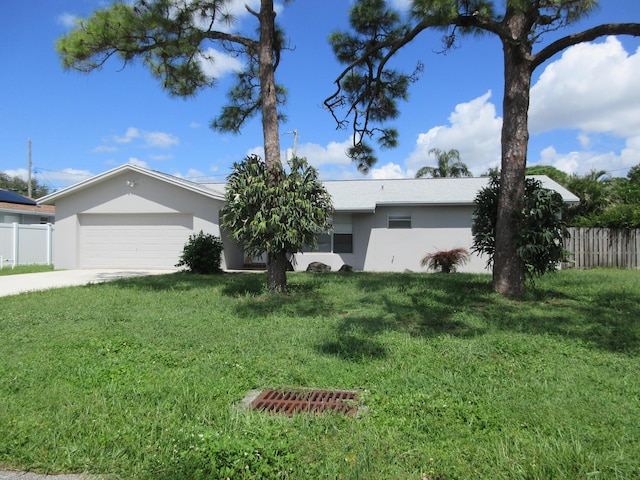 ranch-style house featuring stucco siding, fence, concrete driveway, a front yard, and a garage