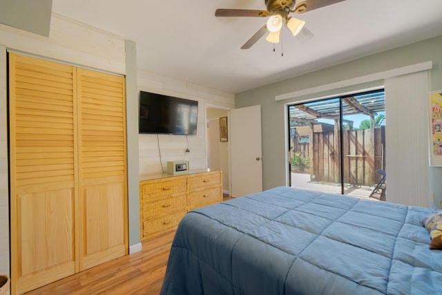 bedroom featuring light wood finished floors, a ceiling fan, and access to outside