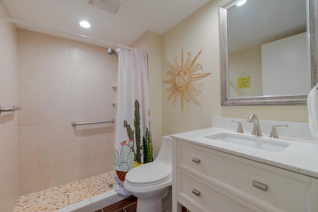 bathroom featuring visible vents, tiled shower, toilet, and vanity