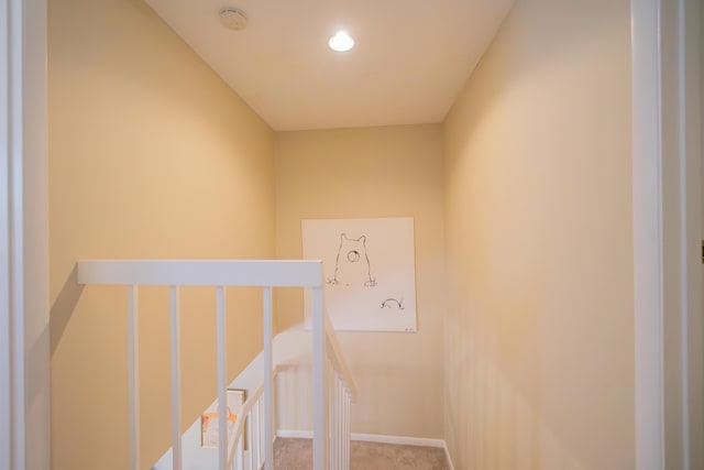 stairs with baseboards and carpet floors