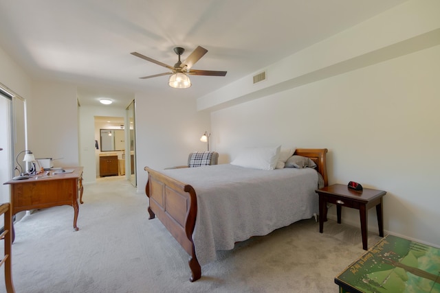 bedroom with baseboards, visible vents, ensuite bath, ceiling fan, and light colored carpet