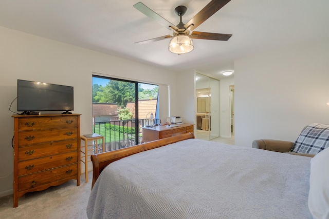 bedroom featuring access to exterior, light colored carpet, ensuite bathroom, and a ceiling fan