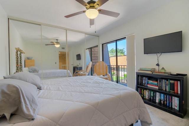 carpeted bedroom with access to outside, a ceiling fan, and a closet