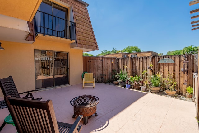 view of patio featuring a fenced backyard and an outdoor fire pit