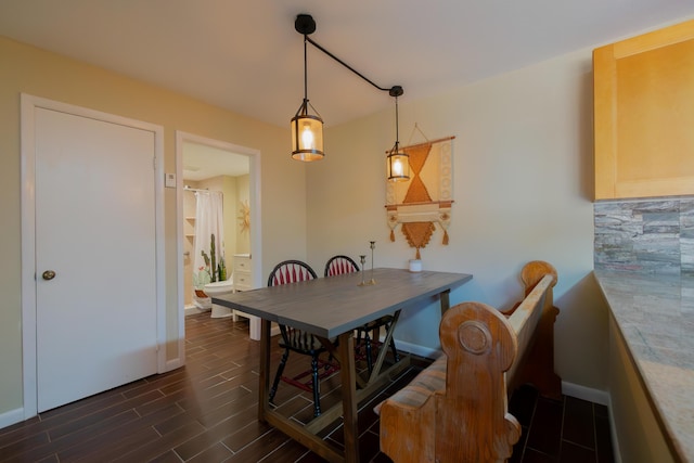 dining area with baseboards and wood finish floors